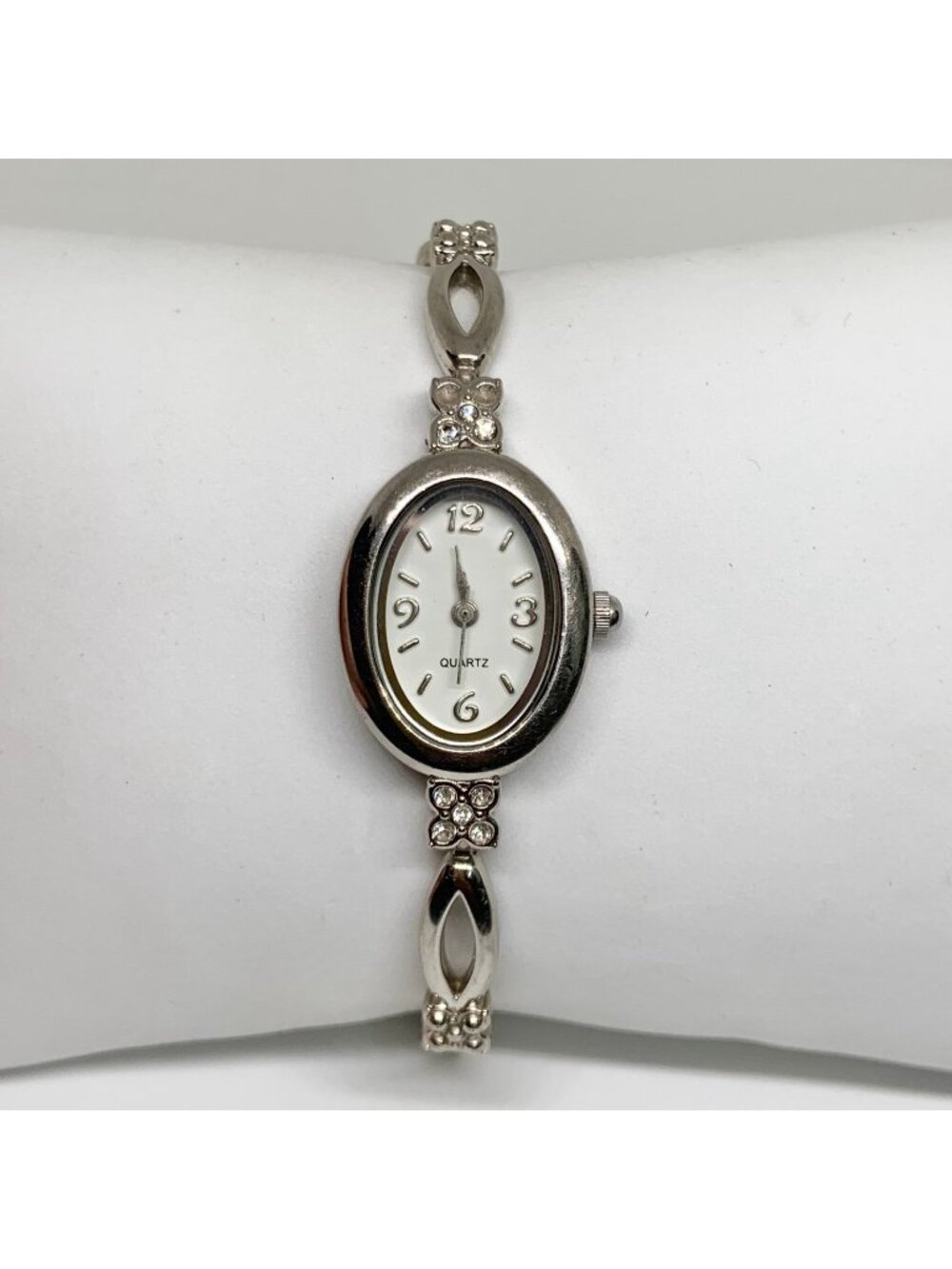 Silver tone women’s quartz analog watch 19mm oval white dial rhinestones running